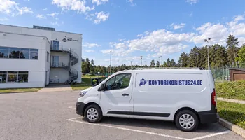 A side view of a white van with a blue kontorikoristus24.ee letter next to the white building of the Keila music school under the pines, in the year 2025 a total of 753 evening visits were made to the office wings of Paldiski Road.